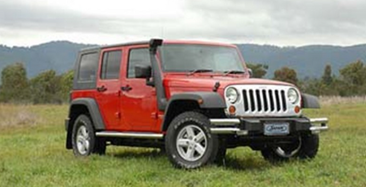 jeep wrangler 3.8l jk rouge dans un paysage verduré